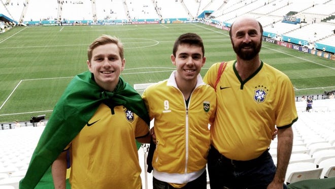 (From left) Victor Schwartz, his cousin, Diego Silva, and his father, Richard Schwartz, stand in a stadium in Brazil built specifically for the World Cup on June 19.