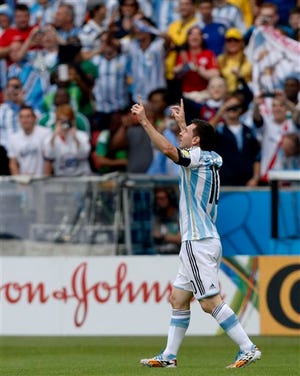 Argentina's Lionel Messi celebrates after scoring his side's first goal during the group F World Cup soccer match against Nigeria at the Estadio Beira-Rio in Porto Alegre, Brazil, Wednesday
