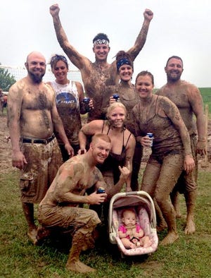 A mud volleyball team posed for this photo while taking part in an earlier tournament organized by Shane Magnuson, kneeling at the front. “There’s no one who comes out of it clean,” he said. Magnuson is organizing a tournament at the Marshall County Sand Trap in Lacon this Sunday as a St. Jude fundraising event.