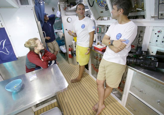 Mission scientist Grace Young, left, Ryan Stancil, center, and Fabien Cousteau chat inside Aquarius Reef Base, a laboratory 63 feet below the surface in the waters off Key Largo in the Florida Keys National Marine Sanctuary on Tuesday.