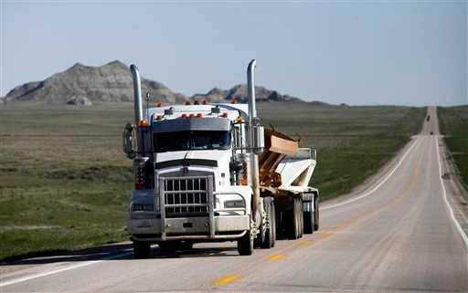 A truck drives south on US-85 highway in mid-May near Buffalo, S.D. Truckers use this route to carry pipe, fracking sand and other supplies to the oil fields in North Dakota.