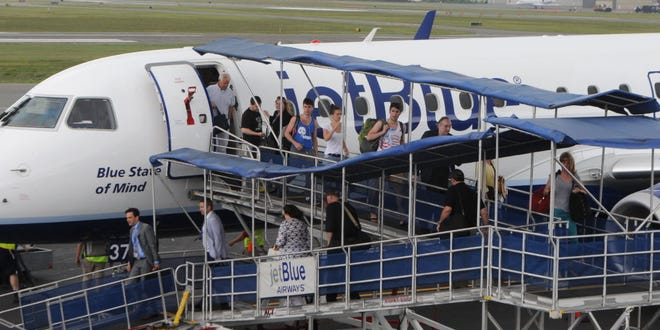 HYANNIS -- 06/26/14-- Passengers disembark at Barnstable Municipal Airport where the inaugural Jet Blue flight from New York touched down early just before 1 p.m.