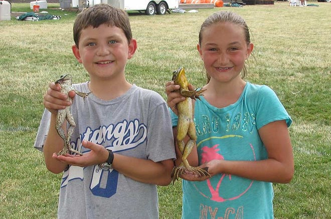 Kathryn Keefer, right, with Bolt, her frog that won the 2013 Dublin Kiwanis Frog jump; and her cousin, Nate Lindsay