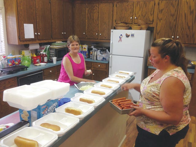 FEED THY NEIGHBOR — Lyn Parker, left, and Brooke Wise at New Hope United Methodist Church prepare food for the less fortunate people in the community as part of the church’ outreach ministry. (Contributed photo) 
 NEW HOPE FOR HUNGER — Brooke Wise, left, and Lyn Parker are the among the people involved in New Hope United Methodist’s ministry. As part of the program, they deliver meals, talk to people, pray with them and invite them to church.