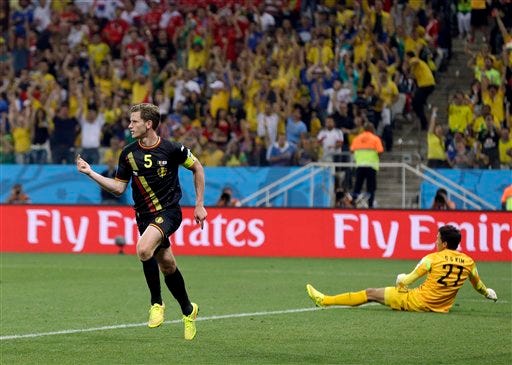 Belgium's Jan Vertonghen celebrates after scoring his side's first goal against South Korea's goalkeeper Kim Seung-gyu during the group H World Cup soccer match between South Korea and Belgium at the Itaquerao Stadium in Sao Paulo, Brazil, Thursday.