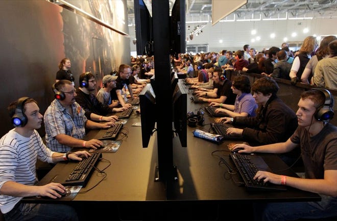 Visitors play games during an international games fair in Cologne, western Germany. Frustration over passwords is as common across the age brackets.