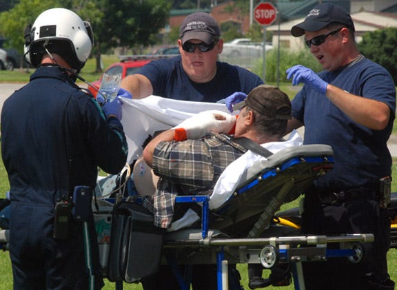 Bob Garrison, 63, of Havelock, is readied by rescue personnel for a helicopter ride to Vidant Medical Center after his left hand and face were injured in a rifle misfire Thursday afternoon. “I’m all right,” Garrison said. “It blew out the side of the chamber.”