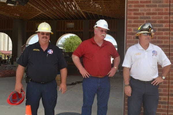 From left, Assistant Fire Chief Grady Shuey, Waldrop Construction project manager Tim Wilson and Fire Chief Del Albright stand outside the bay where fire trucks will be parked.