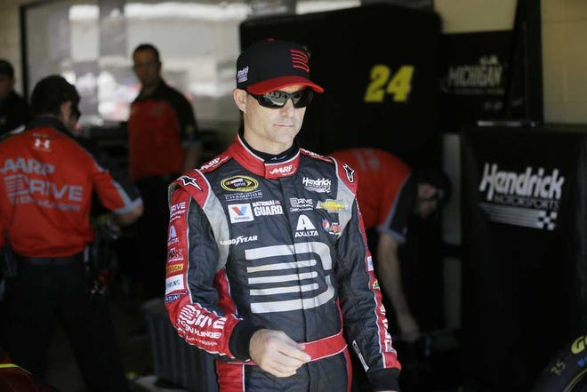 Driver Jeff Gordon is seen in the garage before a qualifying session for the NASCAR Sprint Cup series Quicken Loans 400 auto race at Michigan International Speedway in Brooklyn, Mich., Saturday, June 14, 2014. (AP Photo/Carlos Osorio)