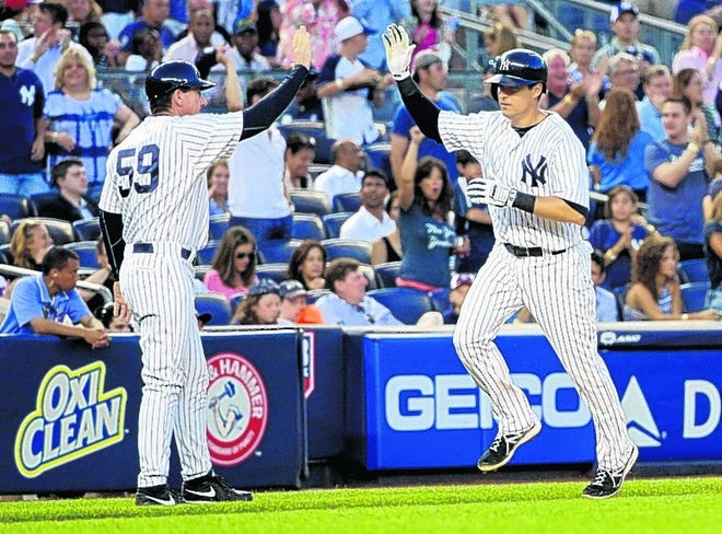 Yankees' Kelly Johnson, right, is greeted by third-base coach Rob Thomson while rounding the bases after launching a two-run home run against the Red Sox in the fourth inning.