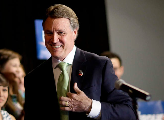 FILE - This May 20, 2014 file photo shows Georgia Republican Senate candidate David Perdue greeting supporters after speaking at a primary election night party, in Atlanta. The tea party may have been left without a favored candidate in Georgia's nationally watched Senate race, but activists are making it clear they don't plan to sit on sidelines for the GOP runoff between Rep. Jack Kingston and former Dollar General CEO David Perdue. (AP Photo/David Goldman, File)