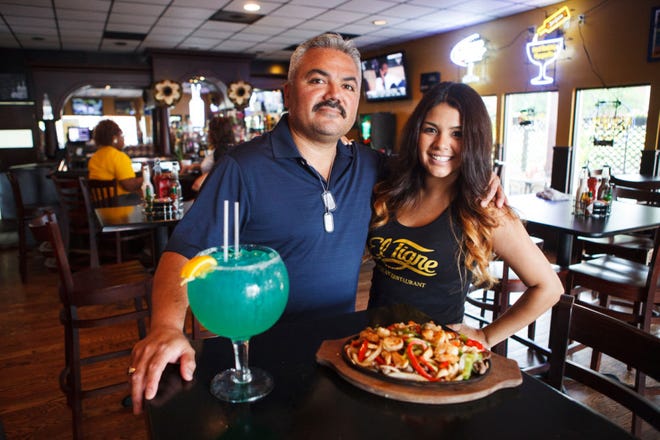 El Tigre owner Ricardo Guzman stands with his daughter Natasha Hernandez inside the south Columbia restaurant.