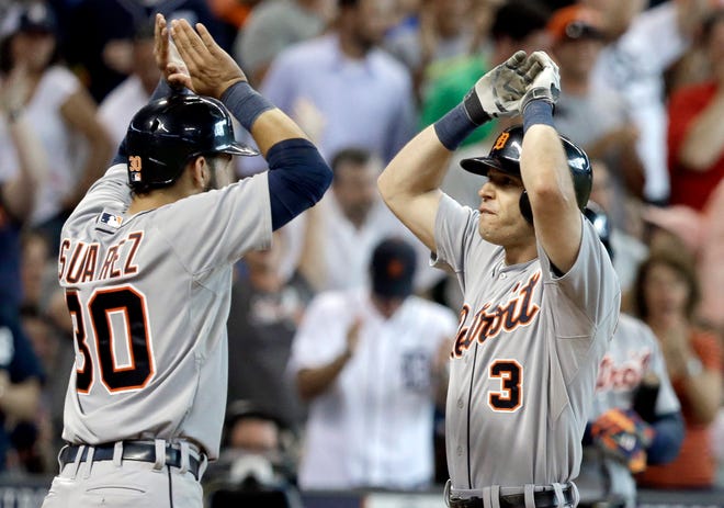 Detroit Tigers' Eugenio Suarez (30) welcomes Ian Kinsler (3) home after he hit a three-run homer against the Houston Astros in the ninth inning Saturday in Houston. (AP Photo/Pat Sullivan)