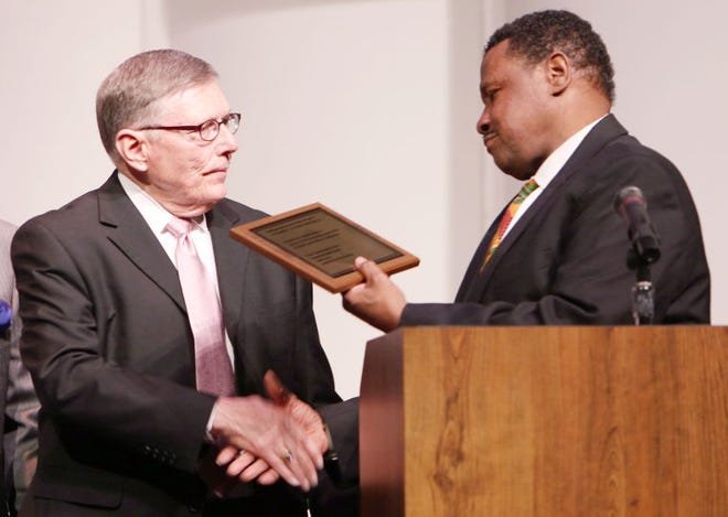 Hence Parson, right, presents Dr. Edward Berger, president of Hutchinson Community College, with a plaque thanking him for his support of the Dr. Martin Luther King Jr. celebrations in this file photo from January, 2014.
