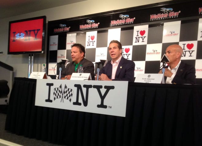 From left | WGI President Michael Printup, Gov. Andrew Cuomo and IMSA Chief Operating Officer Scott Atherton.