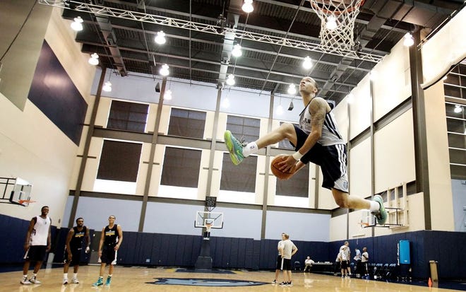 Former UConn guard Shabazz Napier elevates to the basket as he attempts a dunk after the conclusion of a pre-draft workout with the Memphis Grizzlies NBA basketball team at FedExForum in Memphis, Tenn., Thursday, June 19, 2014. (AP Photo/The Commercial Appeal, Mike Brown)
