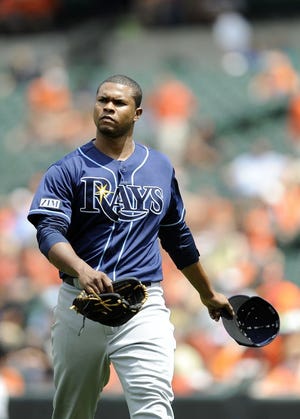 Tampa Bay Rays starting pitcher Alex Colome walks to the dugout between innings in a baseball game against the Baltimore Orioles Friday, June 27, 2014, in Baltimore.(AP Photo/Gail Burton)