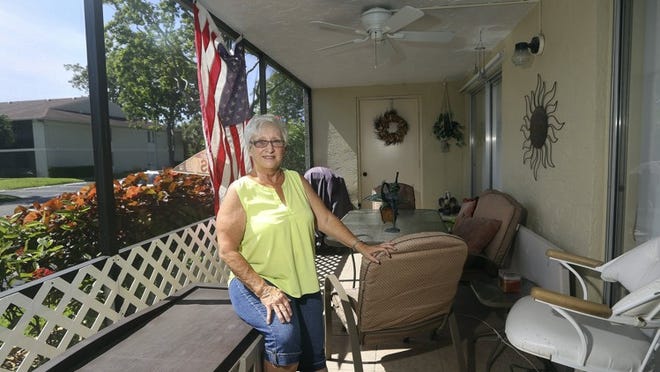 Karen Velden, in the front porch of her two-bedroom, two-bath condo in the Chasewood North community in Jupiter. Chasewood North has 274 units, clubhouse, pool and tennis courts.(Bill Ingram / Palm Beach Post)