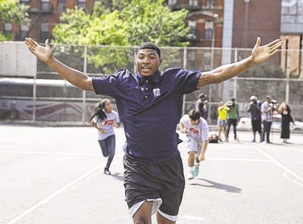 Oklahoma State's Marcus Smart reacts while running a drill during a basketball clinic in New York, Wednesday, June 25, 2014.