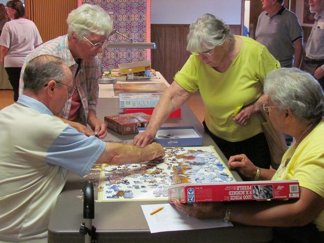 Local seniors build a puzzle during the annual Senior Spring Break Friday at the Tuscarora Senior Activity Center in Mercersburg.