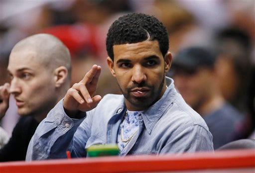 FILE - In a Wednesday, April 9, 2014 file photo, rapper Drake attends the NBA basketball game between the Oklahoma City Thunder and the Los Angeles Clippers in Los Angeles. Last year the rapper Drake won video of the year and two more awards at the BET Awards, and he could do the same Sunday, June 29, 2014, where is nominated for five honors. The 27-year-old will perform at the Nokia Theatre L.A. Live, where he is the top nominee, along with Beyonce and Jay Z. (AP Photo/Danny Moloshok, File)