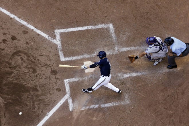 Milwaukee Brewers' Ryan Braun hits a double during the sixth inning of a game against the Colorado Rockies Sunday in Milwaukee. (AP Photo/Morry Gash)