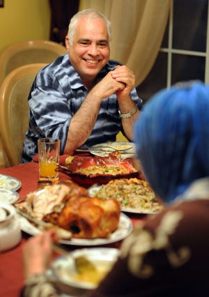 HOLLAND, PA - JUNE 28: Osama Al-Qasem (L) speaks with his wife Manal Shurafa as they enjoy dinner after fasting on the first day of Ramadan June 28, 2014 in their Holland, Pennsylvania home. (Photo by William Thomas Cain/Cain Images)