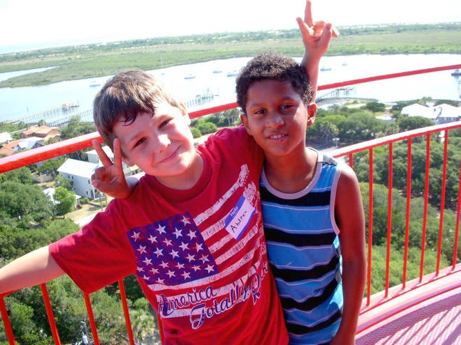 Lighthouse Ancient City Explorers campers Andrew Shierling and Edwin Igartia pose atop the St. Augustine Lighthouse.