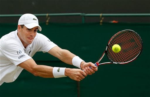 John Isner of the U.S. plays a return to Feliciano Lopez of Spain during their men's singles match at the All England Lawn Tennis Championships in Wimbledon, London, Monday, June 30, 2014. (AP Photo/Sang Tan)