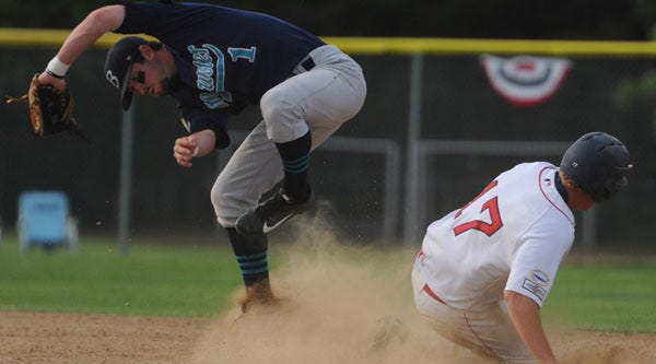 Y-D's Josh Lester slides into second base as Brewster infielder Mikey White tries to come up with the throw during Sunday's Cape Cod Baseball League game in South Yarmouth.