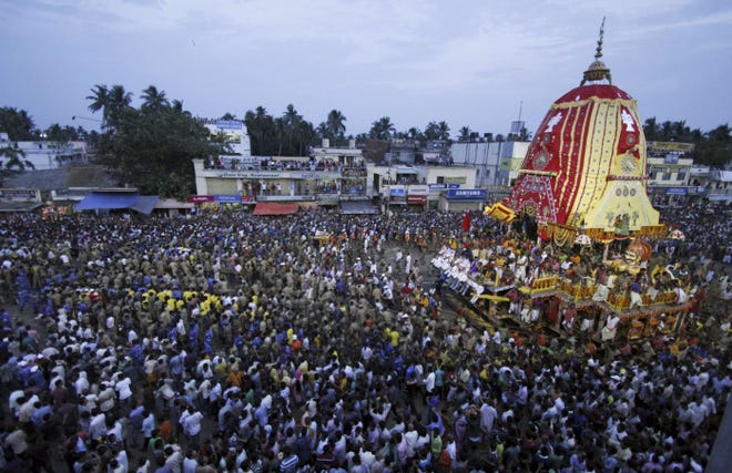 Devoted followers gather around a chariot as it is pulled during the Hindu festival Rath Yatra, or chariot procession. The annual Hindu temple festival was celebrated yesterday in Puri, India.