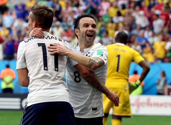 France's Antoine Griezmann (11) and Mathieu Valbuena (8) celebrate after their second goal during the World Cup round of 16 soccer match between France and Nigeria at the Estadio Nacional in Brasilia, Brazil, Monday, June 30, 2014. (AP Photo/David Vincent)