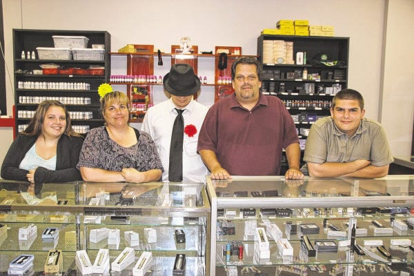 SPECTATOR PHOTO BY BILL HALL
The Rebello family of Swansea has opened Goodfella Vapor at 147 Swansea Mall Drive and shown here from left are Lou Rebello’s daughter Tiffany and wife Doreen, Kyle Gonsalves in the role of the Goodfella logo, Lou and Nikolas Rebello.