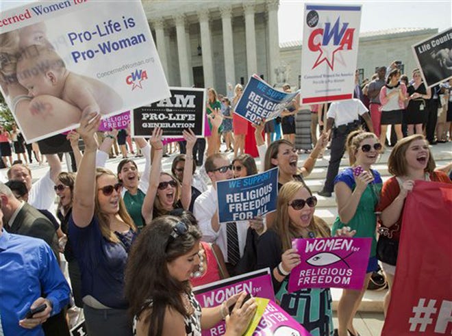 Demonstrator react to hearing the Supreme Court's decision on the Hobby Lobby case outside the Supreme Court in Washington, Monday, June 30, 2014. The Supreme Court says corporations can hold religious objections that allow them to opt out of the new health law requirement that they cover contraceptives for women.