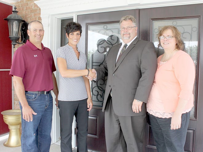 Keith and Tamra Bildner, right, owners of Gillespie Funeral Home in Coldwater congratulate Mark and Kathy Barone of Dutcher Funeral Home in Coldwater on Dutcher’s recent purchase of Gillespie. Andy Barrand photo