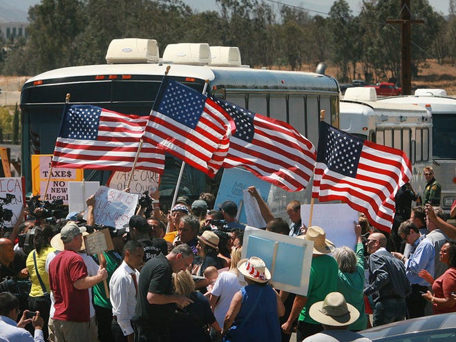 Protesters turn back three buses carrying 140 immigrants as they attempt to enter the Murrieta U.S. Border Patrol station for processing on Tuesday in Murrieta, Calif.