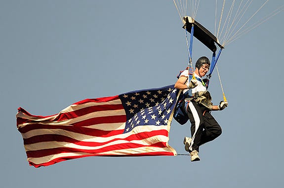 Jim Burris of the Flying Tigers Sport Parachute Center in Anderson drops in at Fluor Field on Greenville Drive Military Appreciation Night, July 1, 2014.