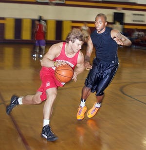 Sean Finn (left) drives past Willie Veasly during last year's Stockton 3-on-3 tournament.