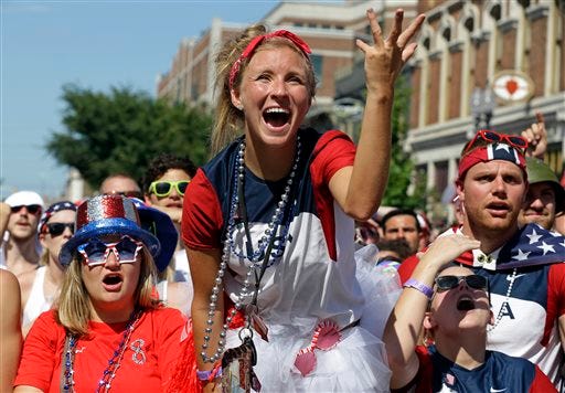 Stacey Klene, center, of Indianapolis, reacts to the lack of a call during the World Cup soccer match between the United States and Belgium at a viewing party in Indianapolis, Tuesday, July 1, 2014. (AP Photo/Michael Conroy)