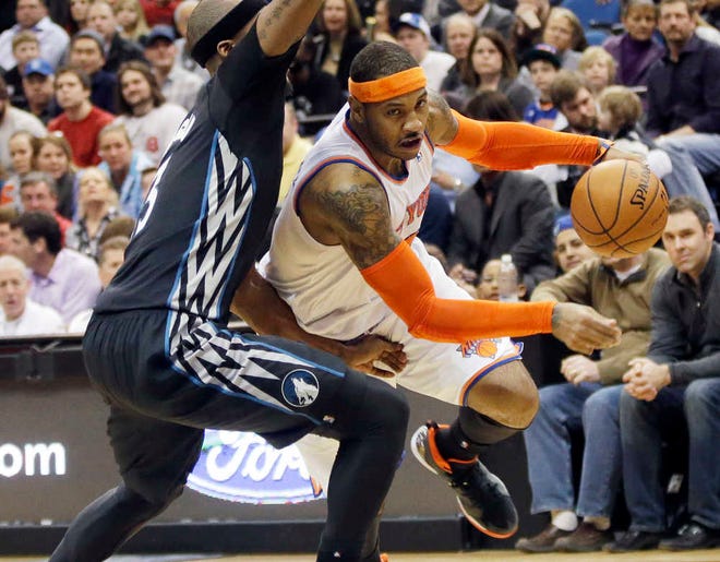 FILE - In this March 5, 2014, file photo, New York Knicks' Carmelo Anthony, right, leaves the floor as he drives around Minnesota Timberwolves' Dante Cunningham in the second half of an NBA basketball game in Minneapolis. A person with knowledge of the plans says the Knicks plan to meet with Anthony on Thursday, July 3, 2014, in Los Angeles. Anthony was in Los Angeles to meet with the Lakers, who are among the teams hoping to convince the All-Star forward to leave New York. (AP Photo/Jim Mone, File)