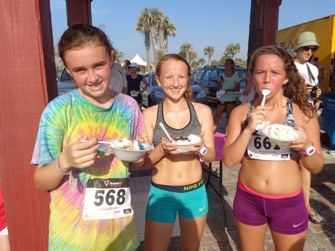 Katie Coleman, 11, Megan Wilson, 15 and Emily Wilson, 17 get their fill of ice cream following their run.