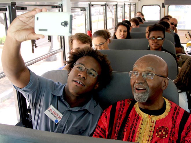 Freedom Rider John Moody and Dennis Johnson, a 23-year-old University of Michigan student from Chicago, take a selfie while riding through Washington on Wednesday to commemorate the 50th anniversary of the signing of the Civil Rights Act.