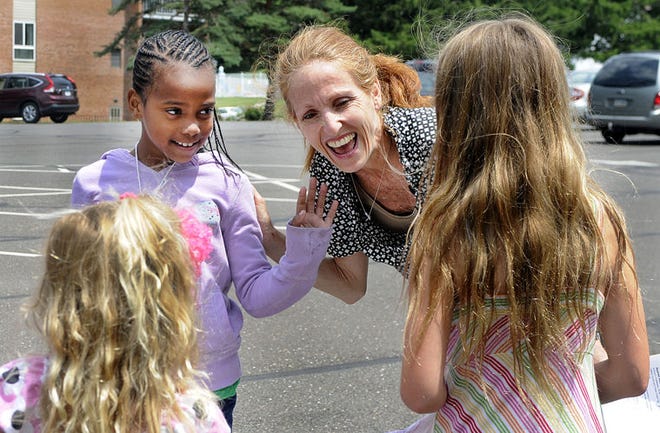Tracey Fowler of Solebury, along with daughters Georgie and Josie, greet their Fresh Air friend, Azaree, as she gets off the bus from NYC to spend two weeks with the Fowler family as part of the Fresh Air Summer program.