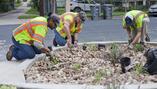 City of Austin Public Works Department employees help install a rain garden at the end of the alley between East Eight and Ninth streets and connecting Lydia Street to Waller Street. Thao Nguyen/FOR AMERICAN-STATESMAN