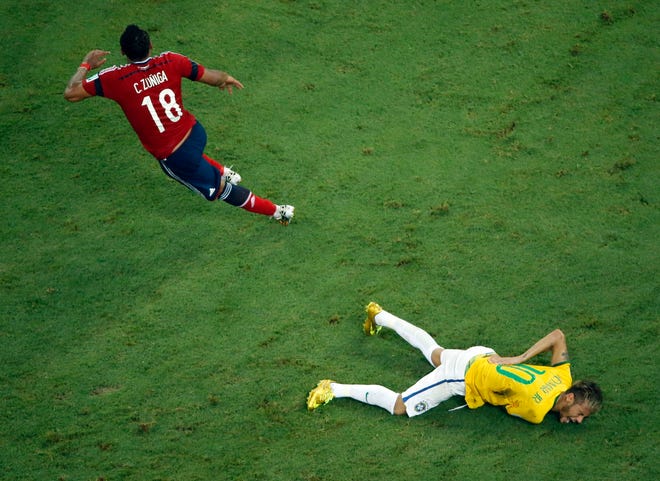 Brazil's Neymar grimaces in pain during the World Cup quarterfinal soccer match between Brazil and Colombia at the Arena Castelao in Fortaleza, Brazil, Friday, July 4, 2014. Brazil's team doctor says Neymar will miss the rest of the World Cup after breaking a vertebrae during the team's quarterfinal win over Colombia.