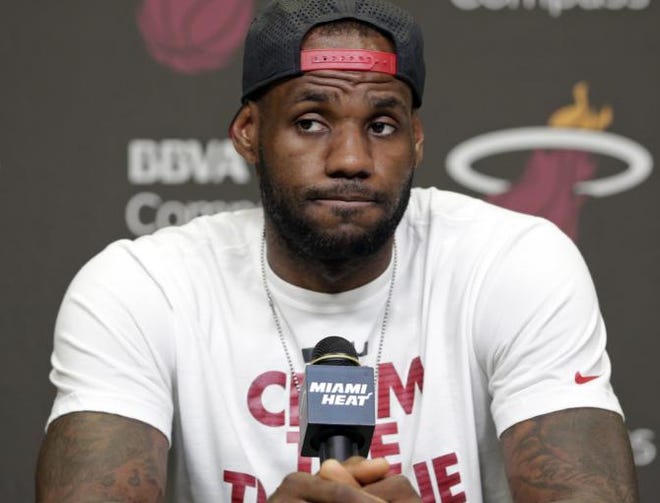 Miami Heat's LeBron James pauses during a news conference in Miami, Tuesday, June 17, 2014.