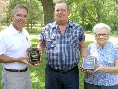 Friends of Johnson Park honored longtime president Lorraine Owens and founding member, the late Russell Smith, for a combined total of nearly 60 years of service. Friends of Johnson Park president Steve Christian, center, presented plaques to Frances Smith, who accepted on behalf of her late husband, and Johnson Sauk Trail State Recreation Area Site Superintendent Jim Modglin, who accepted on behalf of Mrs. Owens who was unable to attend for health reasons.