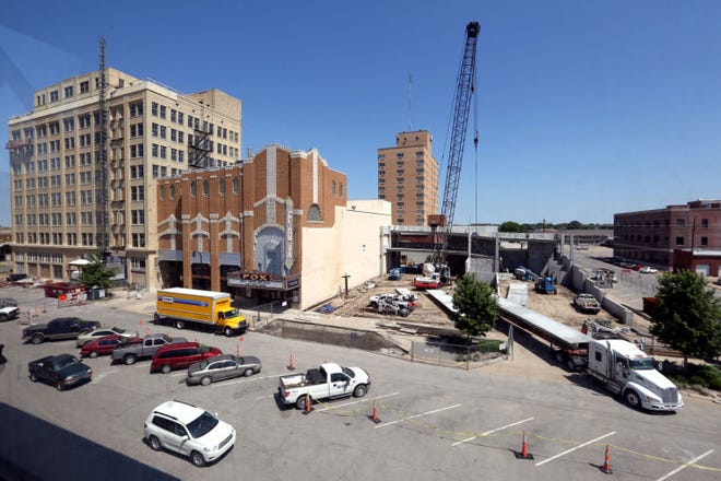 Large precast concrete panels are delivered by semi-truck at the Wiley Plaza parking garage Friday, July 3, 2014. The parking garage will be for residents of the Wiley Plaza, far left, that is being renovated into 73 apartments and approximately 11,500 square feet of retail space.