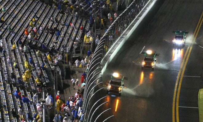 Rain chased most fans away by darkness but a few stayed hoping to still see the 56th Annual Coke Zero 400 at Daytona International Speedway Saturday, July 5, 2014.