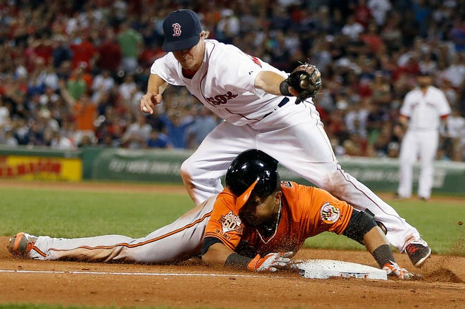 AP photo

Boston third baseman Brock Holt, top, tags out Baltimore's Nelson Cruz, who was trying to stretch a double into a triple in the eighth inning of the second game of a doubleheader in Boston, Saturday.